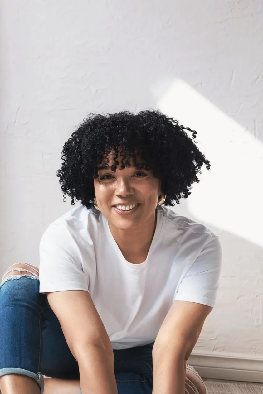 Tight curls 3C to 4A: smiling woman with tight, voluminous curls